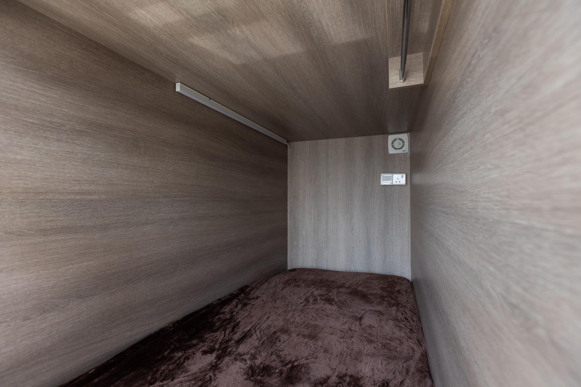 Photograph of the interior of a private sleeping capsule at InterCube hostel in Dubai, offering a comfortable and personal space for travelers