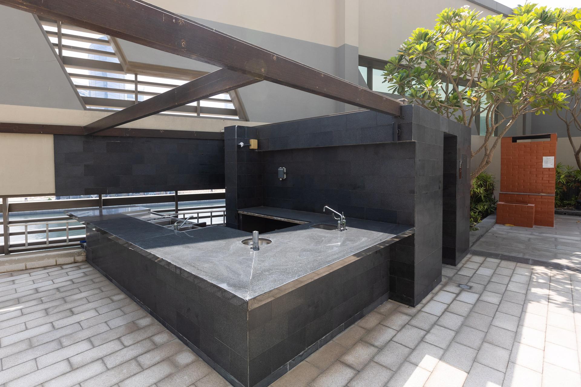 Photograph of an outdoor kitchen area at InterCube hostel in Dubai, equipped with a modern sink and counter space